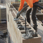 Bracing and securing wooden concrete forms for a foundation pour using 40-inch rebar stakes
