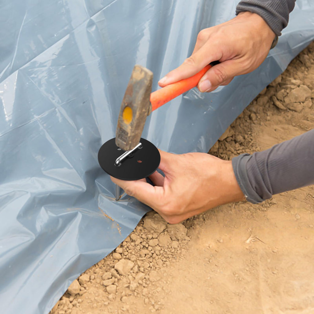 Close-up of round plastic gasket on hot-dip galvanized landscape staple, preventing tears and increasing ground contact