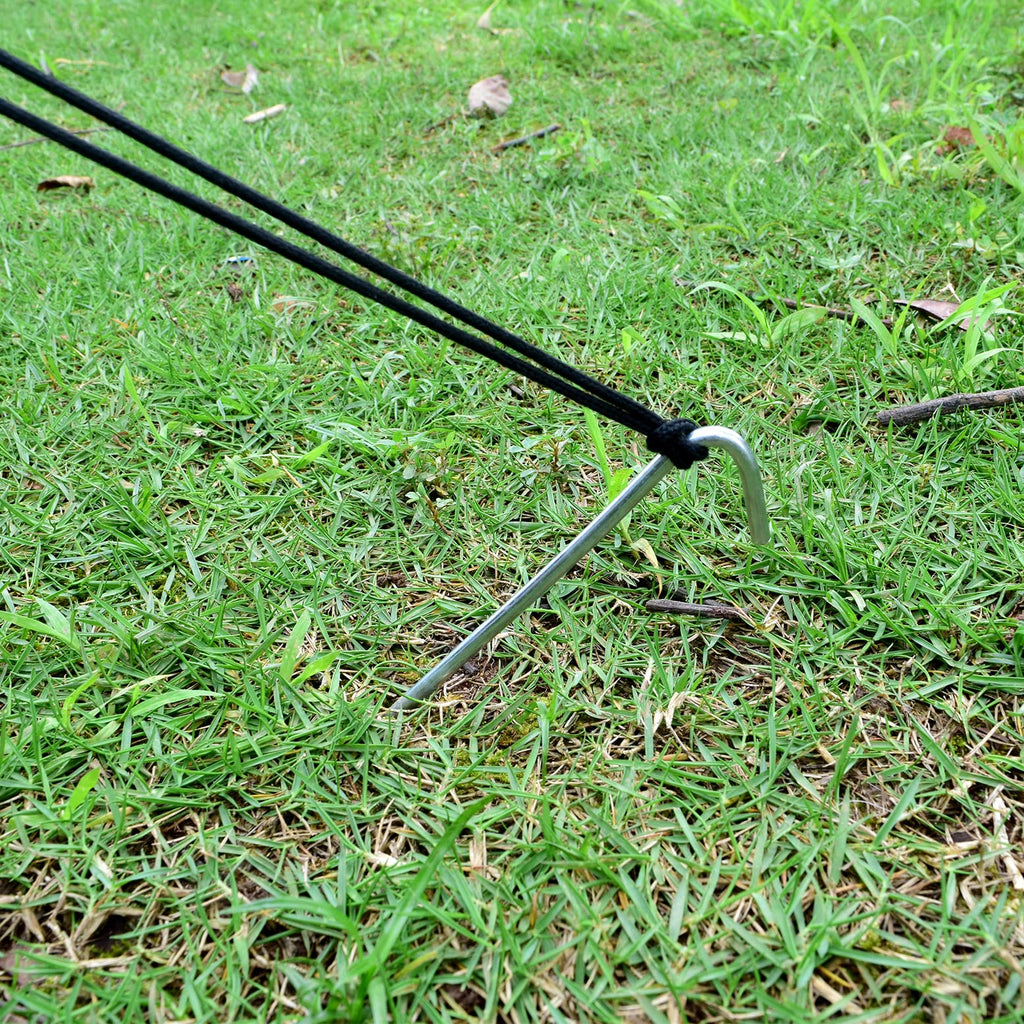 Set of 9-inch heavy duty galvanized steel tent stakes with hooked tops and sharp points, lying on grass