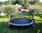 Backyard trampoline fun: a girl jumping while other children watch, surrounded by trees and green lawn
